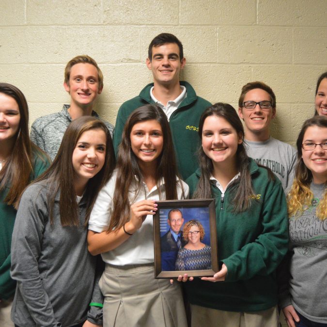 Group Photo of Students Holding Picture of their Teacher