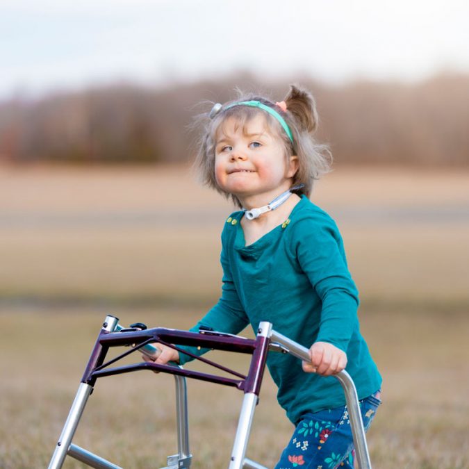 Young Girl with Walker Outside