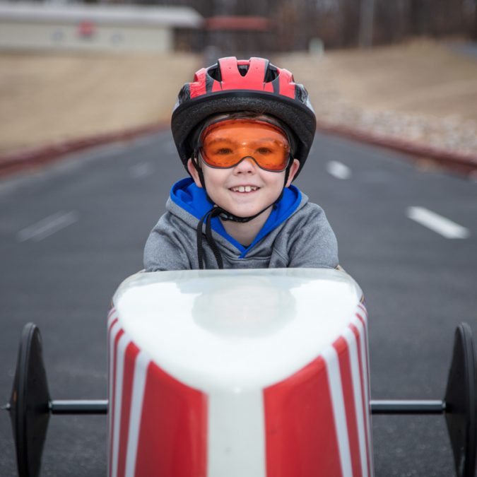 Young Boy in Soap Box Derby Car