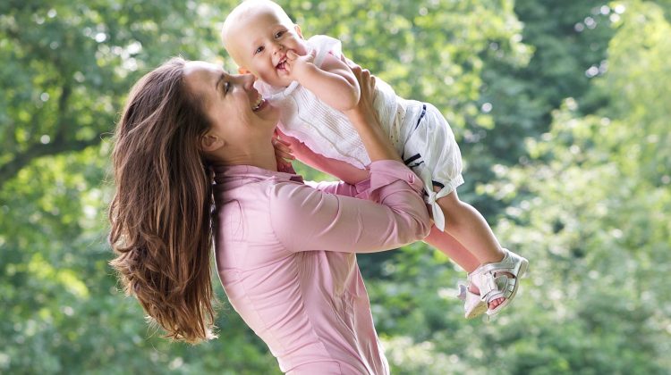 Mother Holding Her Toddler Up in the Air