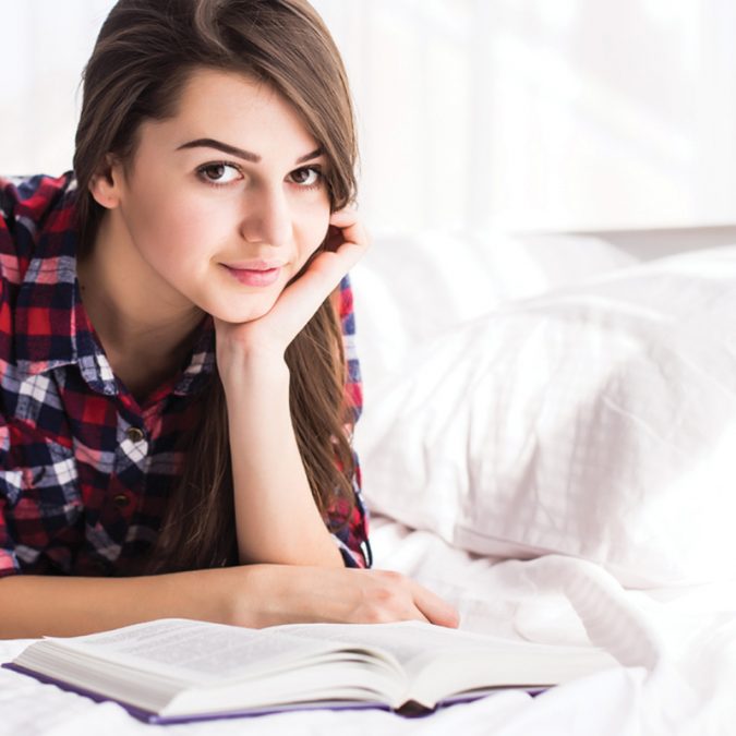 girl studying in bed