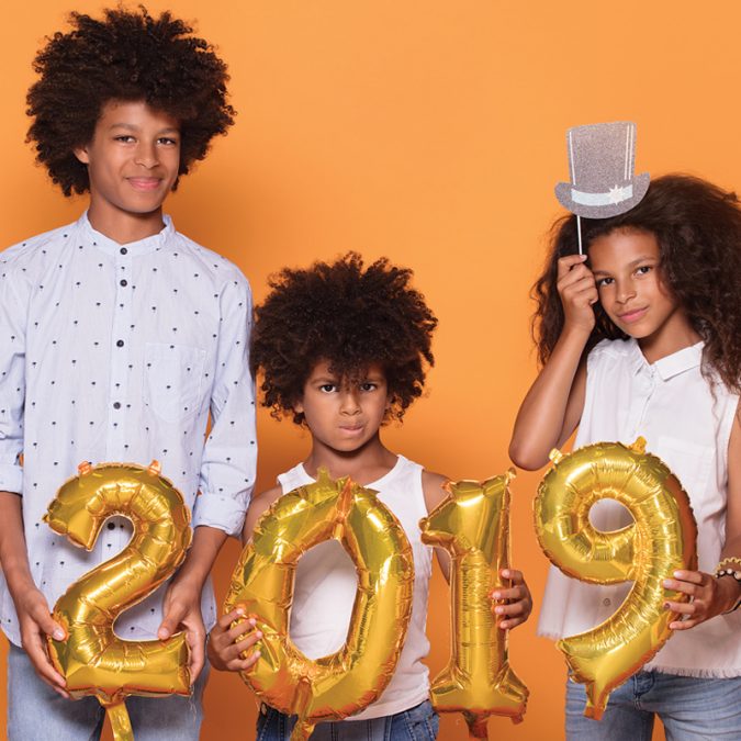 Kids holding 2019 balloons