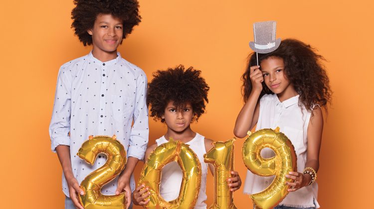 Kids holding 2019 balloons