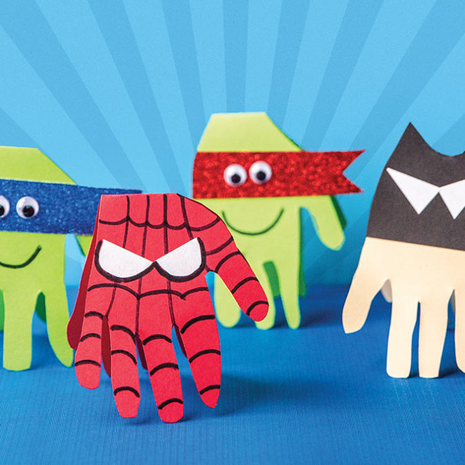 Paper hands decorated like superheros