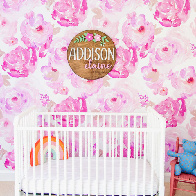 Daughter Addison's bedroom with bright pink, floral wallpaper and wooden sign that says her name