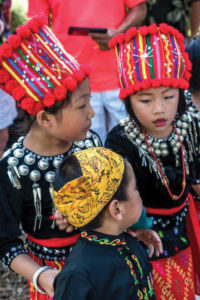 Children wear ceremonial costumes from various cultures