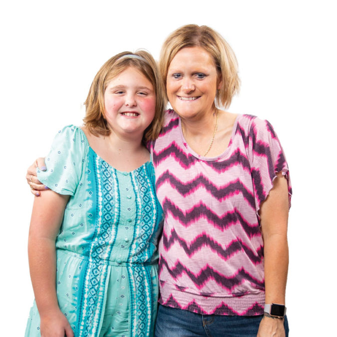 Portrait on white background of Jennifer Hulsey and her granddaughter