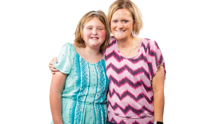 Portrait on white background of Jennifer Hulsey and her granddaughter