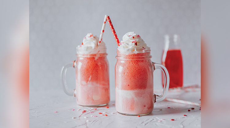 Red and pink floats with whipped cream and sprinkles