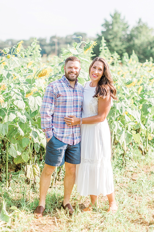 The Howards posing for a photo in a sunflower field