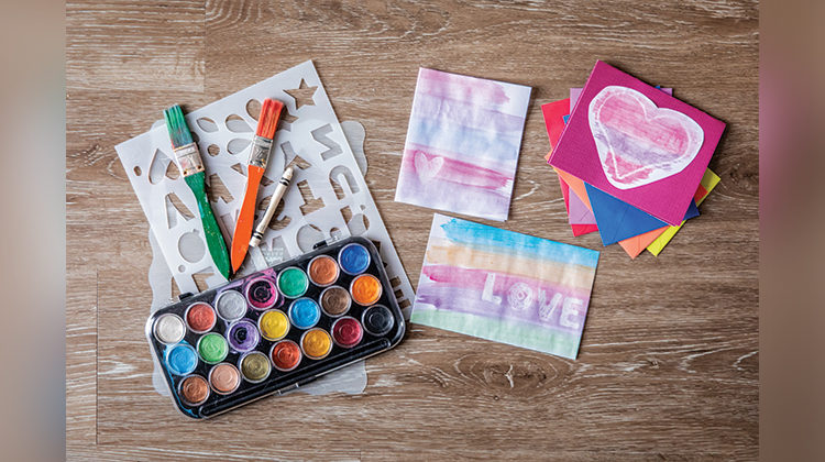 Watercolor supplies on a wooden floor