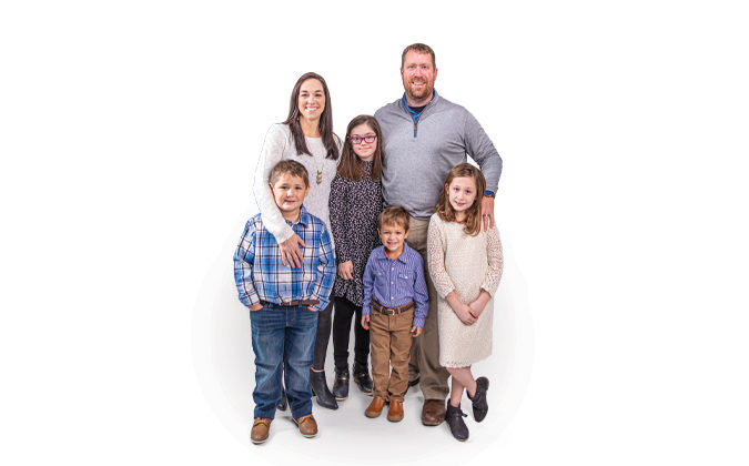 Rick Ebelhar and his family smiling for a photo