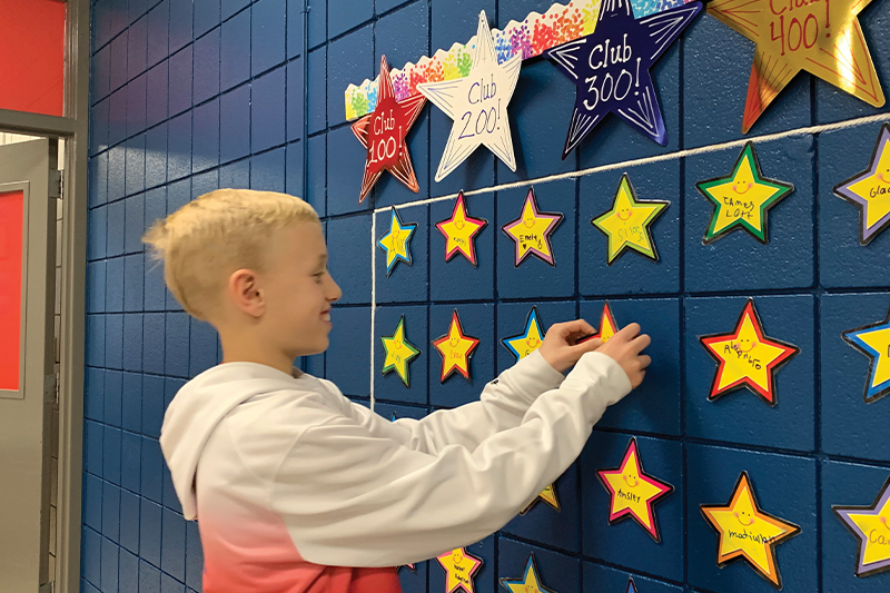 Ace Lilpop, a fifth grade student here at Audubon Elementary, sets his Eagle Up star on the Wall of Fame.